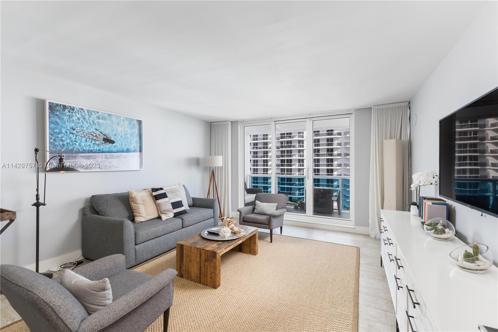 102 24th Street, Unit 1013 Miami Beach, FL 33139 - Photo 20 of 38 a living room with furniture and large window