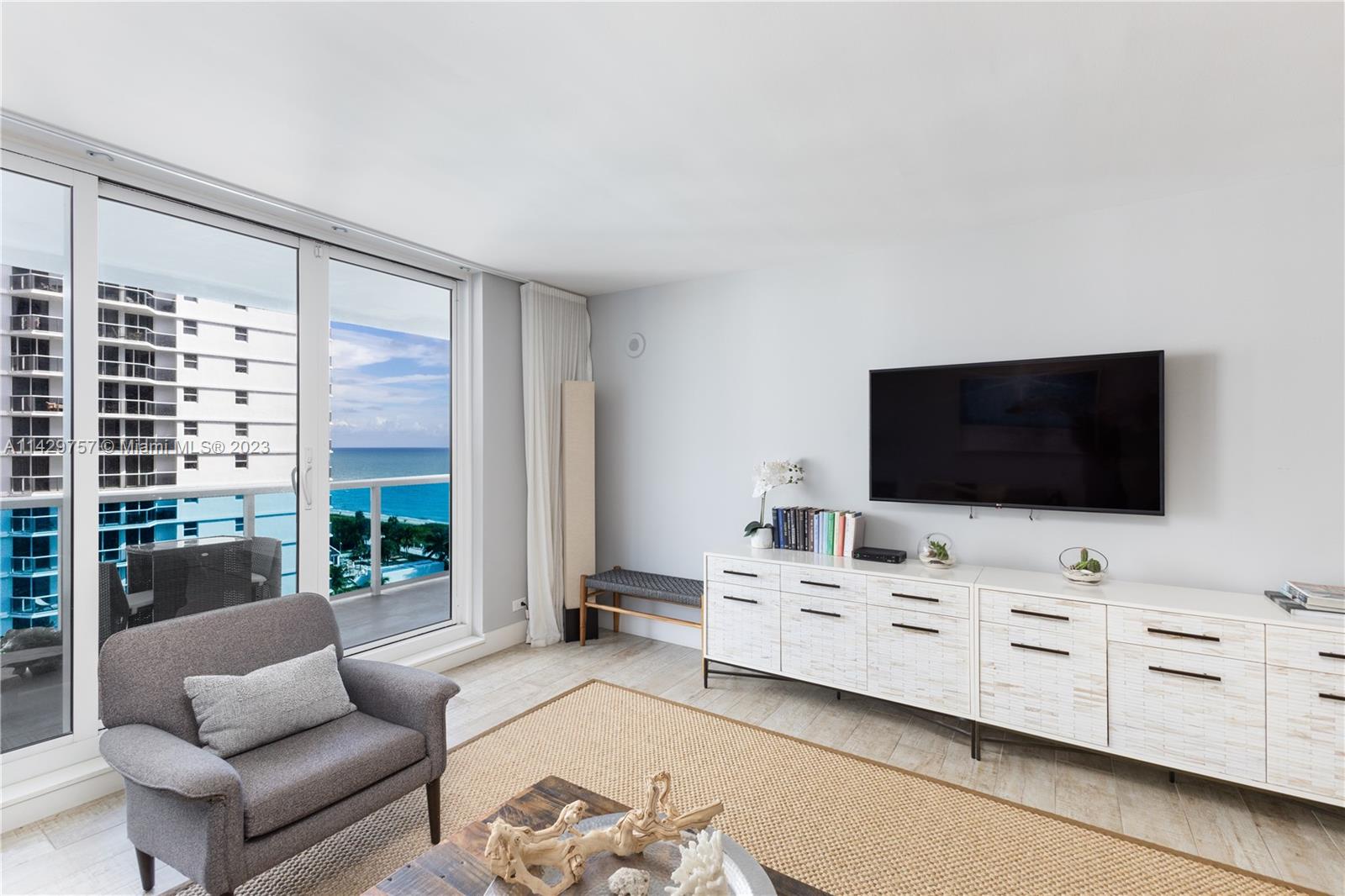 102 24th Street, Unit 1013 Miami Beach, FL 33139 - Photo 21 of 38 a living room with furniture and flat screen tv