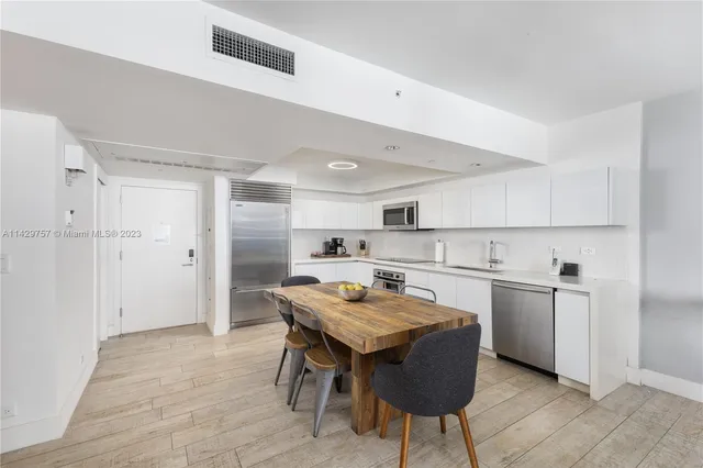 a kitchen with a sink a stove and chairs