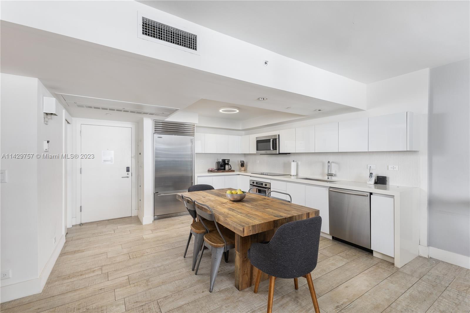 102 24th Street, Unit 1013 Miami Beach, FL 33139 - Photo 24 of 38 a kitchen with a table and chairs in it