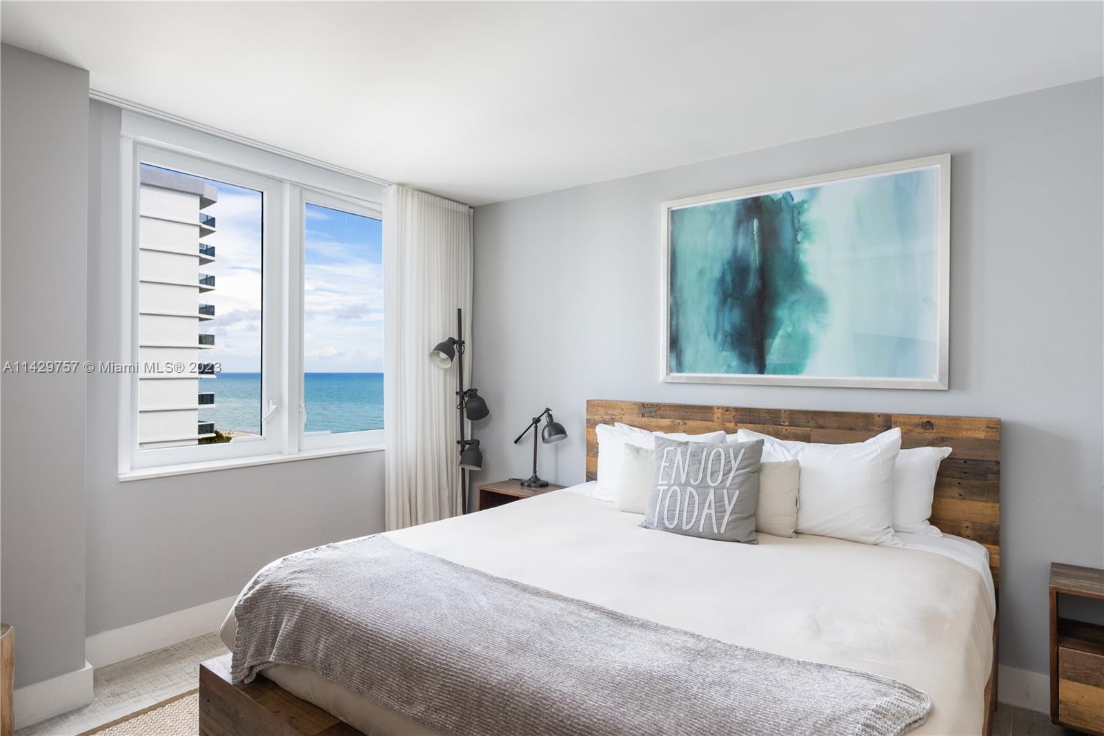 102 24th Street, Unit 1013 Miami Beach, FL 33139 - Photo 30 of 38 a bedroom with a bed and a window