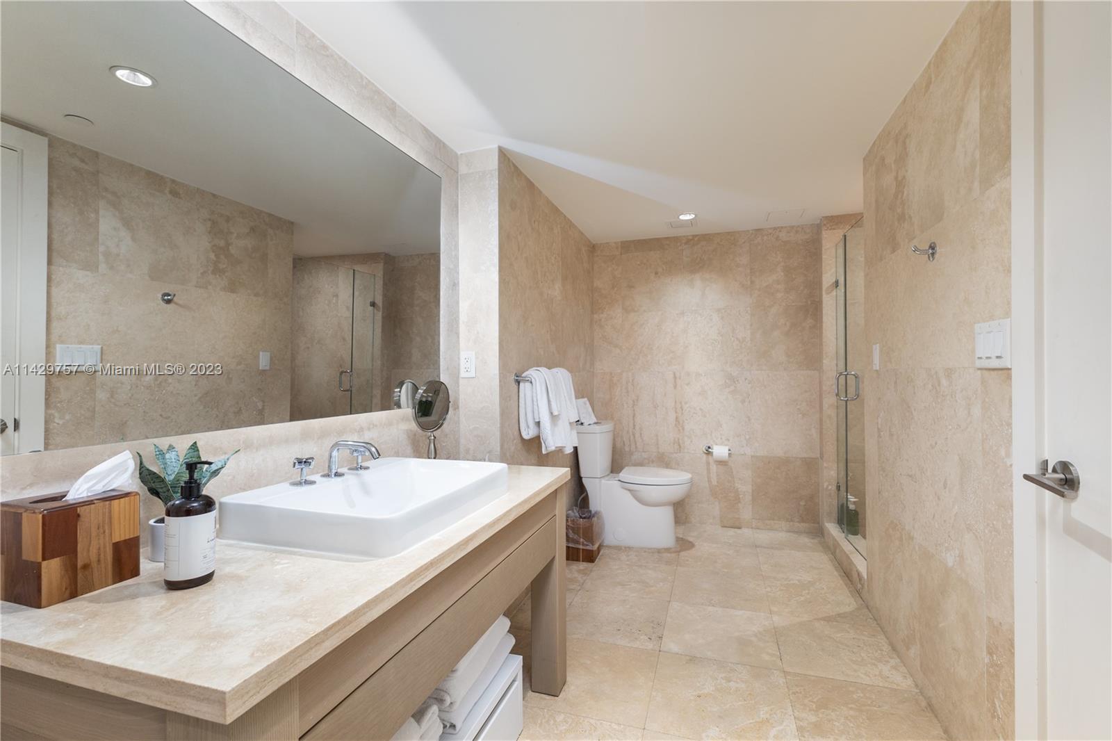 102 24th Street, Unit 1013 Miami Beach, FL 33139 - Photo 33 of 38 a bathroom with a sink a toilet and shower