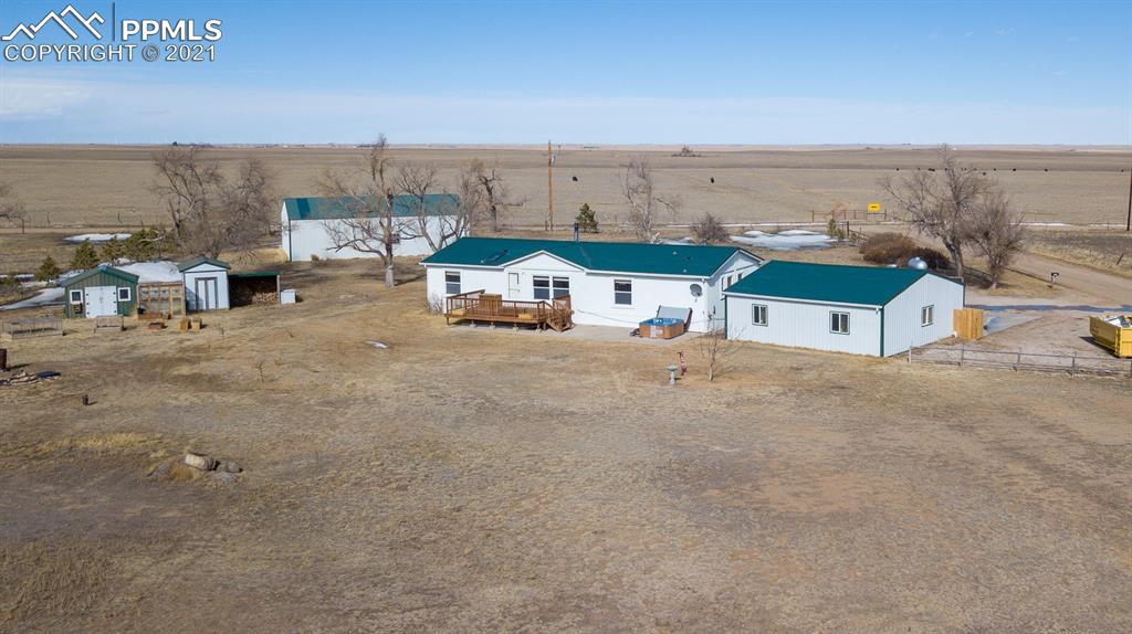 4270 Oil Well Road Yoder, CO 80864 - Photo 11 of 42 Photo to show the layout of the house and outbuildings. Notice the greenhouse, covered garden beds and storage sheds.
