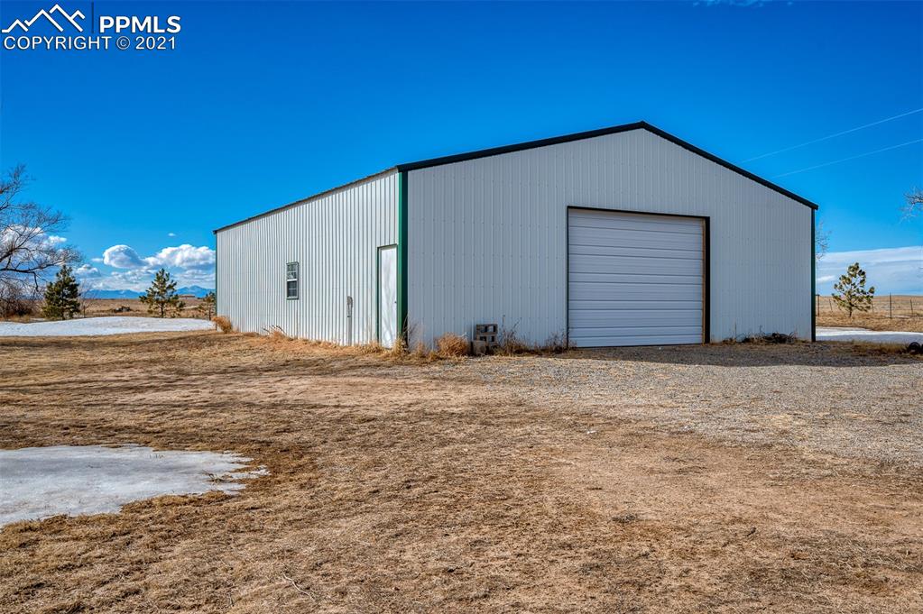 4270 Oil Well Road Yoder, CO 80864 - Photo 4 of 42 The 40x50 shed includes 220V electric service and an oversized 10x14 door. There is a workshop area set up in the back.