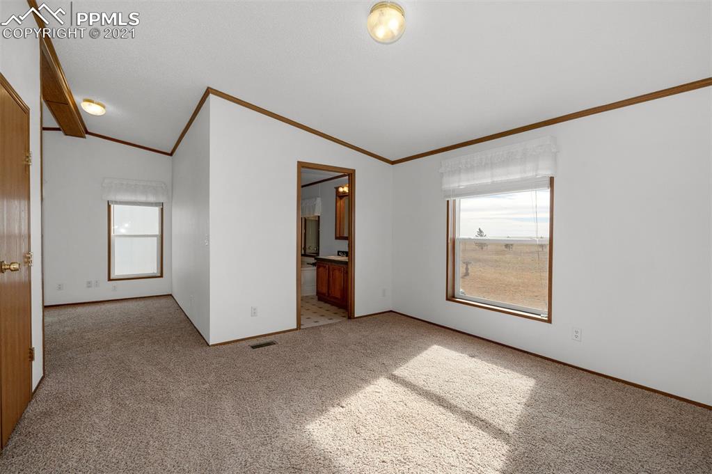 4270 Oil Well Road Yoder, CO 80864 - Photo 10 of 42 Photo of the master bedroom. You can see the entrance to the private bath and the sitting room is just around the corner.