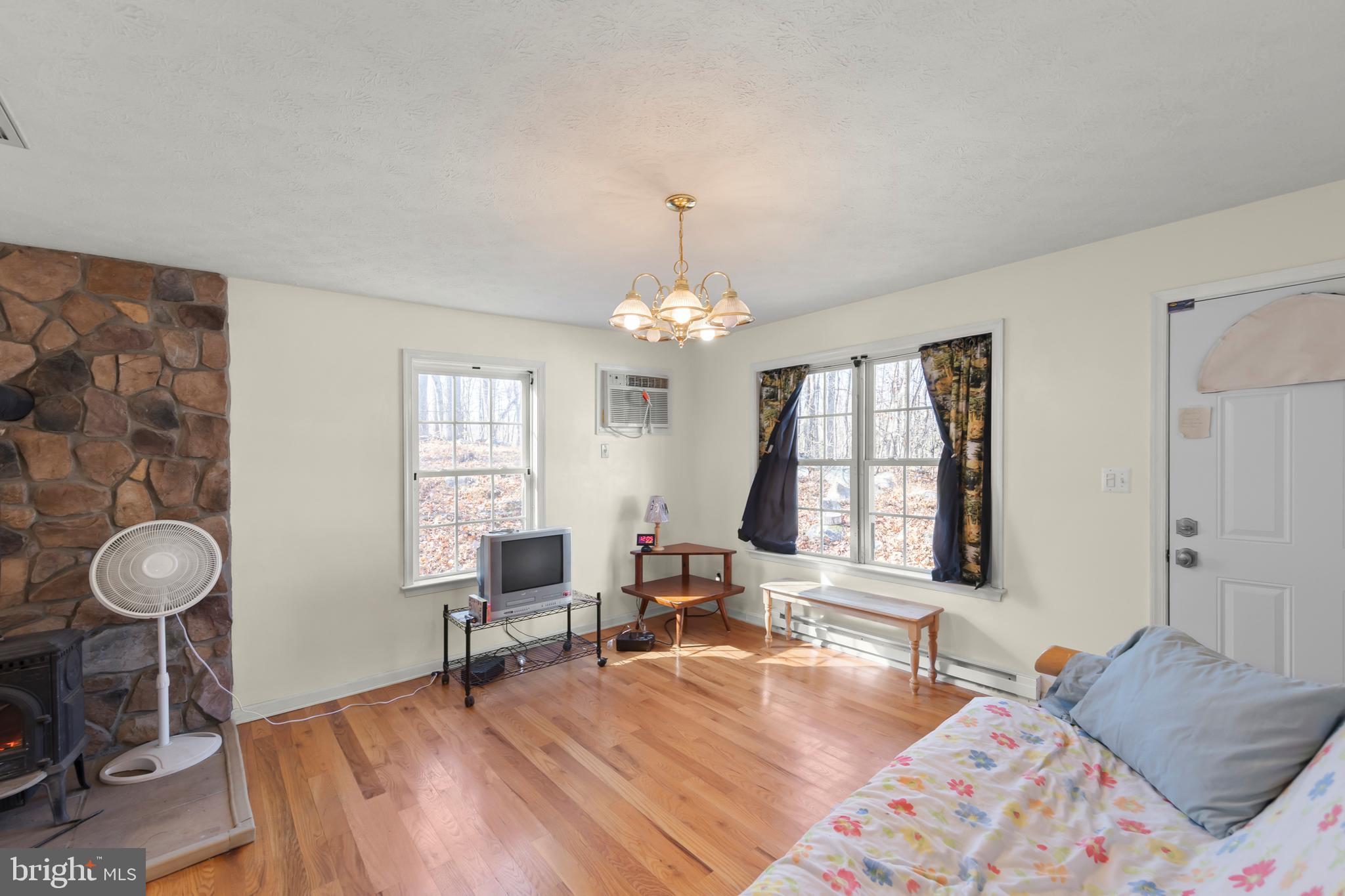 1060 Buffalo Rdg Road Augusta, WV 26704 - Photo 14 of 67 a bedroom with a bed and a chandelier