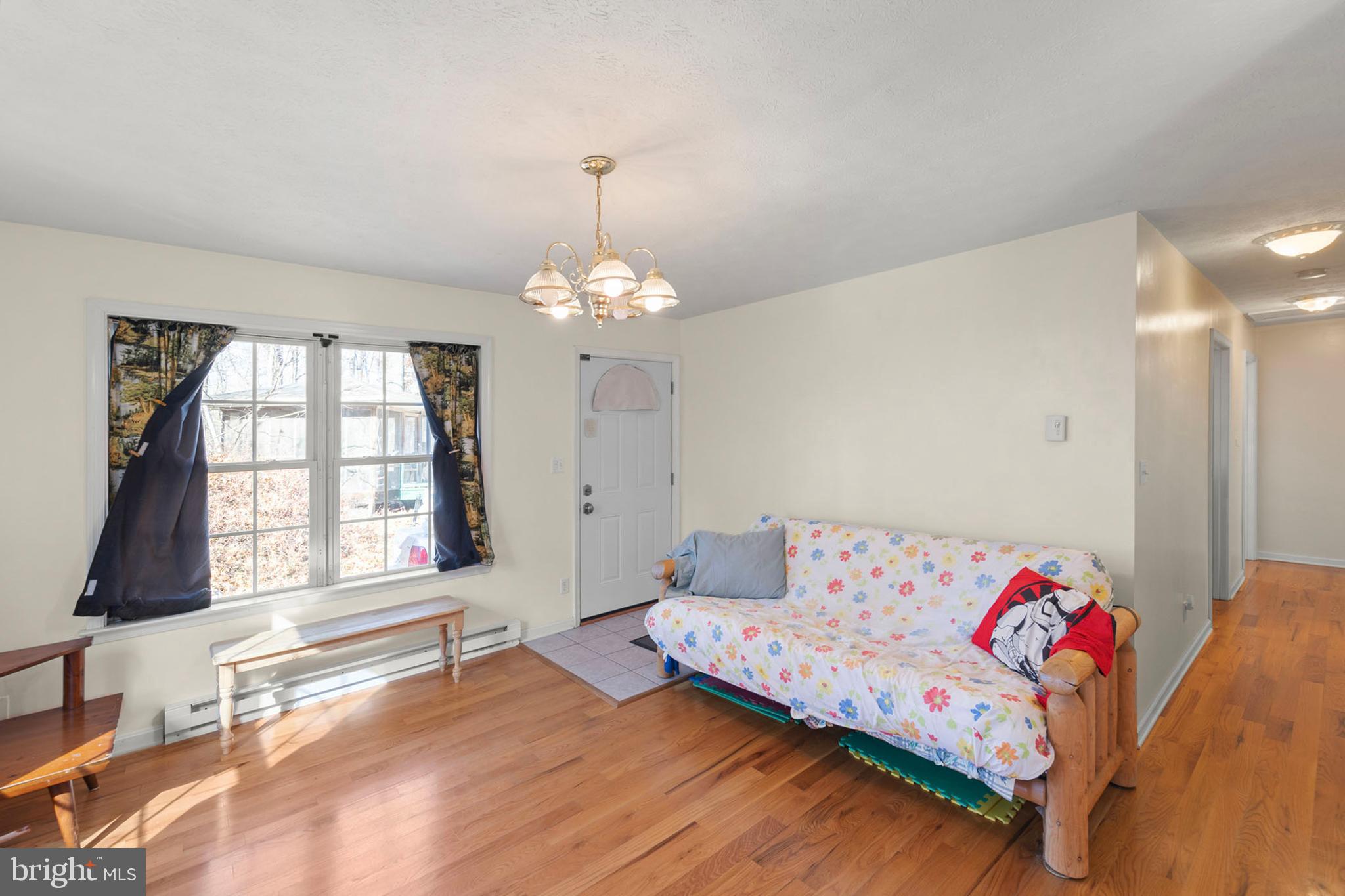 1060 Buffalo Rdg Road Augusta, WV 26704 - Photo 15 of 67 a living room with furniture and a chandelier