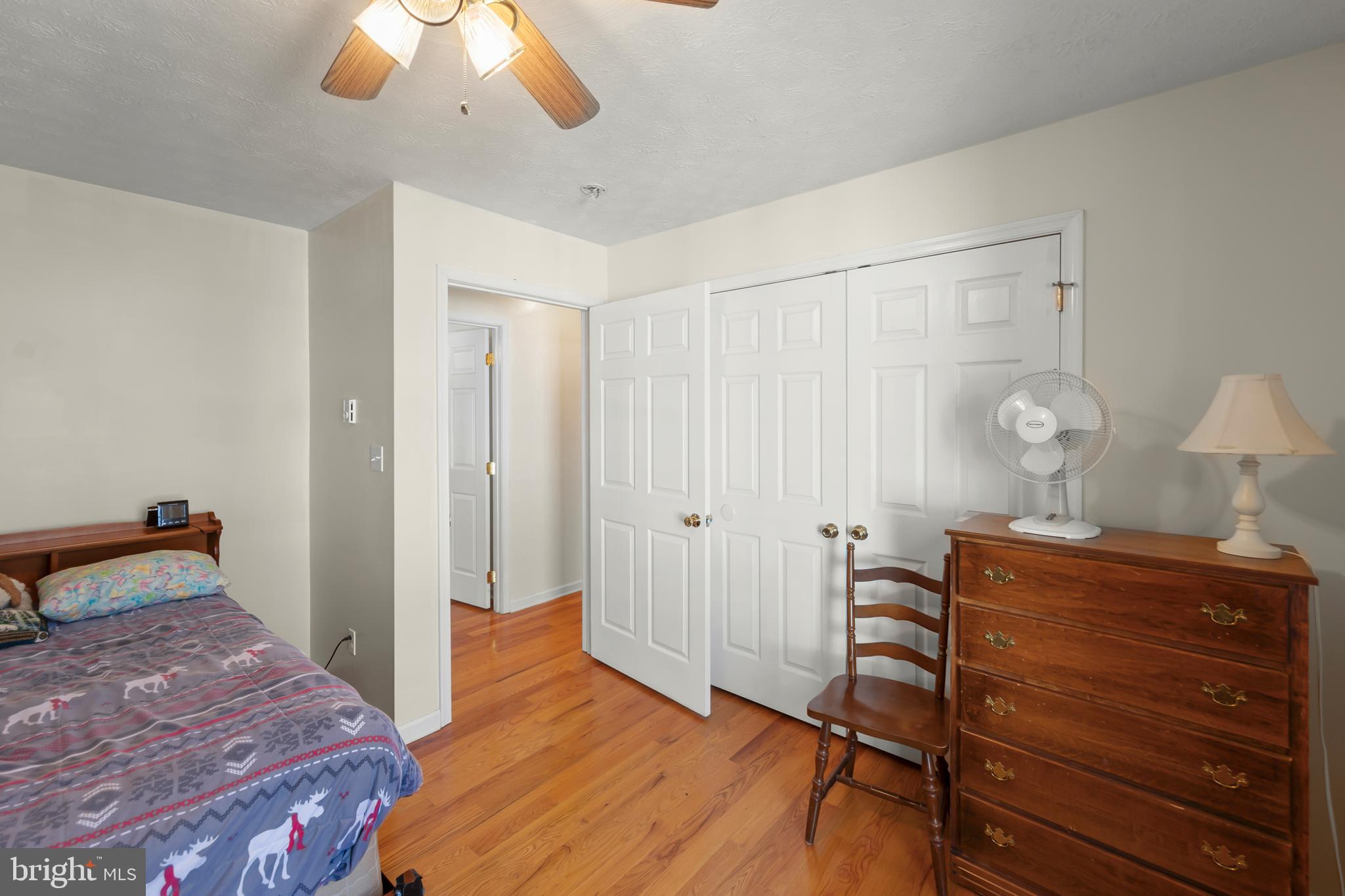 1060 Buffalo Rdg Road Augusta, WV 26704 - Photo 23 of 67 a bedroom with a bed and a chandelier