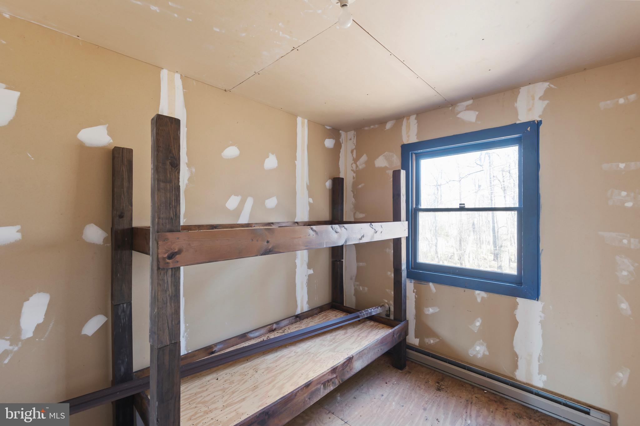 1060 Buffalo Rdg Road Augusta, WV 26704 - Photo 42 of 67 a living room with a bed furniture and a window