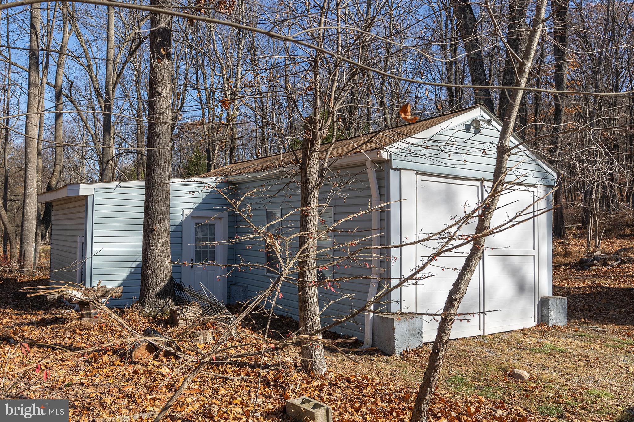 1060 Buffalo Rdg Road Augusta, WV 26704 - Photo 57 of 67 a backyard of a house with large trees and wooden fence