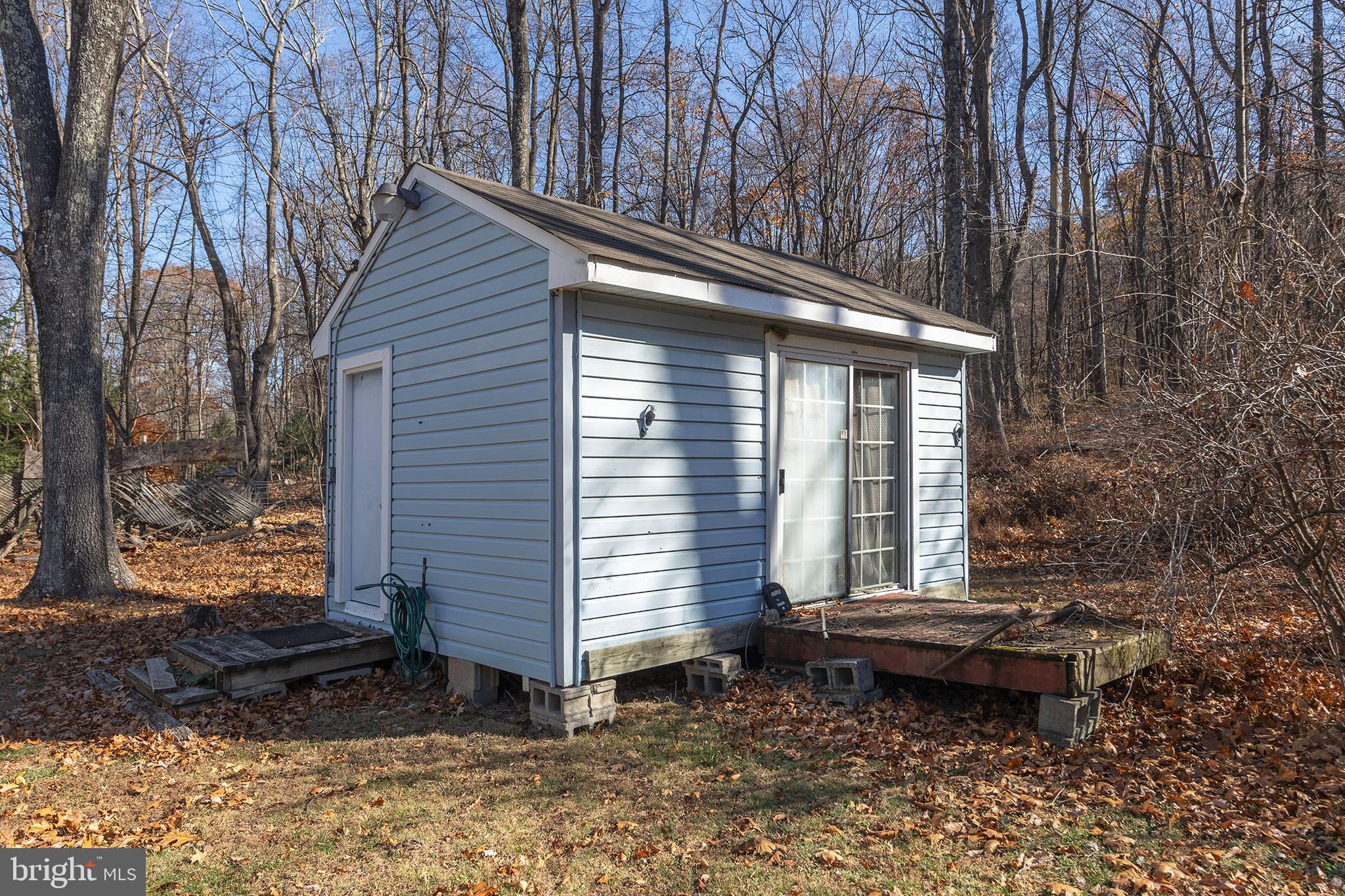 1060 Buffalo Rdg Road Augusta, WV 26704 - Photo 62 of 67 a backyard of a house with barbeque oven and outdoor seating