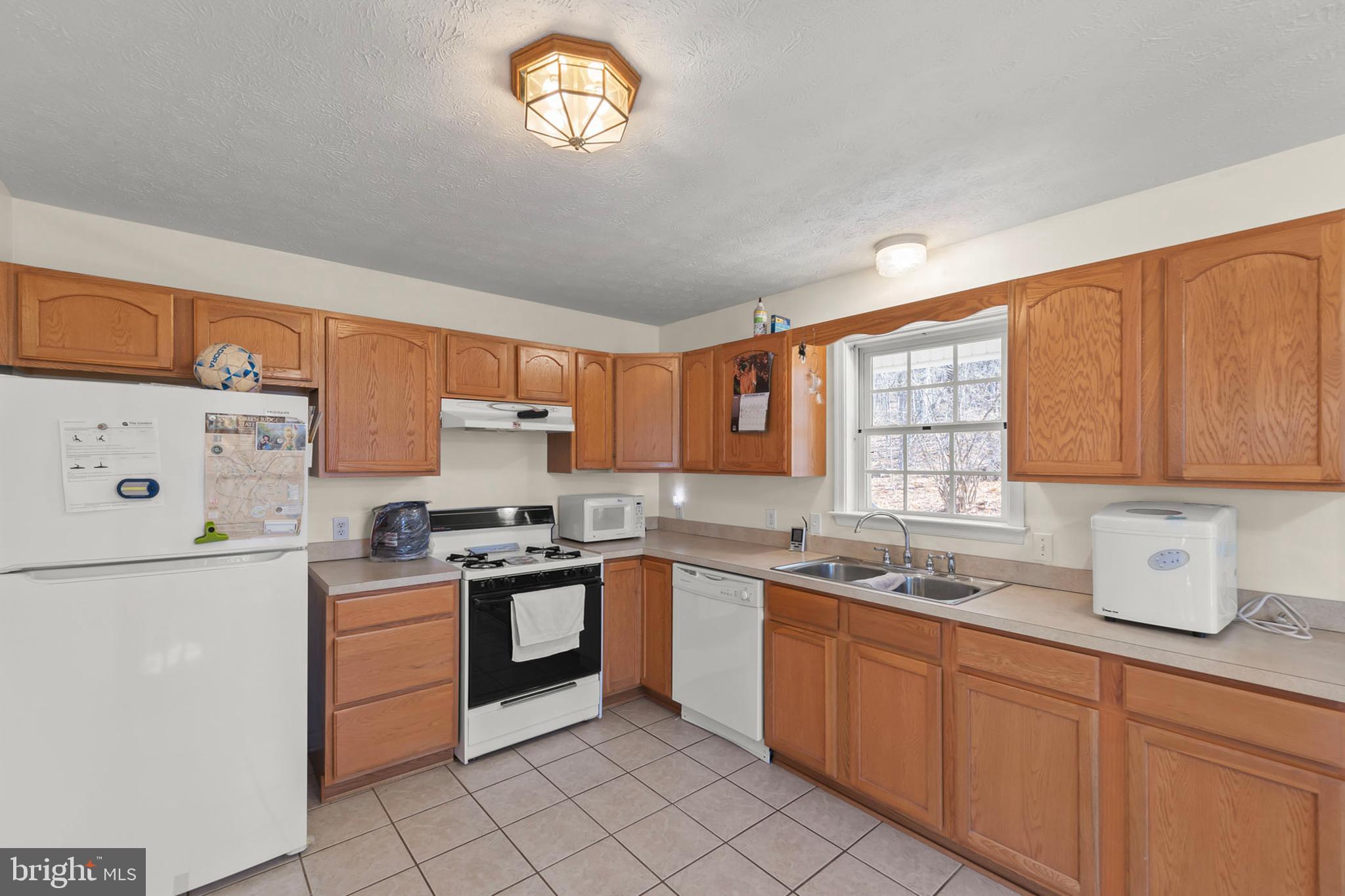 1060 Buffalo Rdg Road Augusta, WV 26704 - Photo 7 of 67 a kitchen with a sink a stove and cabinets