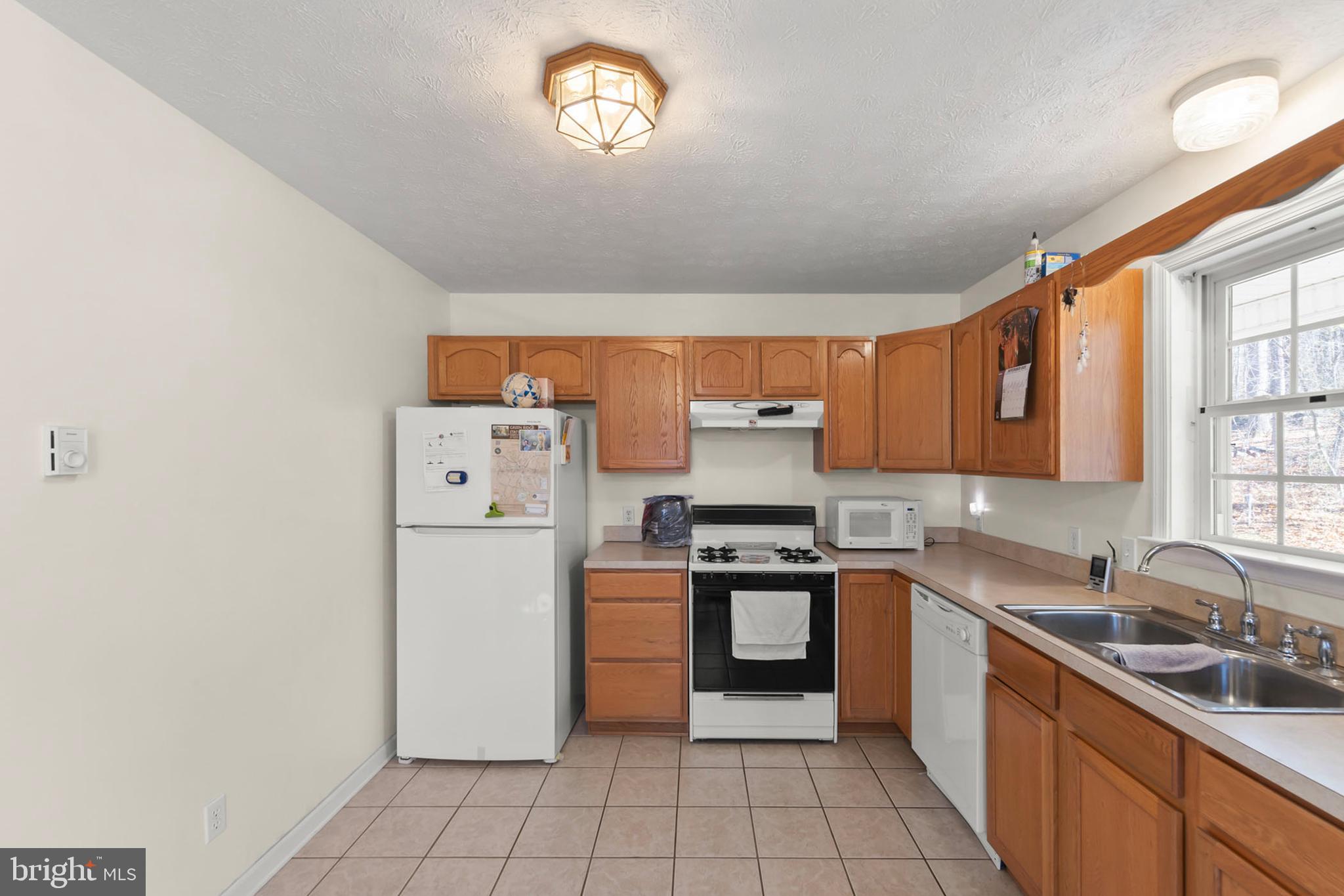 1060 Buffalo Rdg Road Augusta, WV 26704 - Photo 8 of 67 a kitchen with a stove top oven sink and cabinets