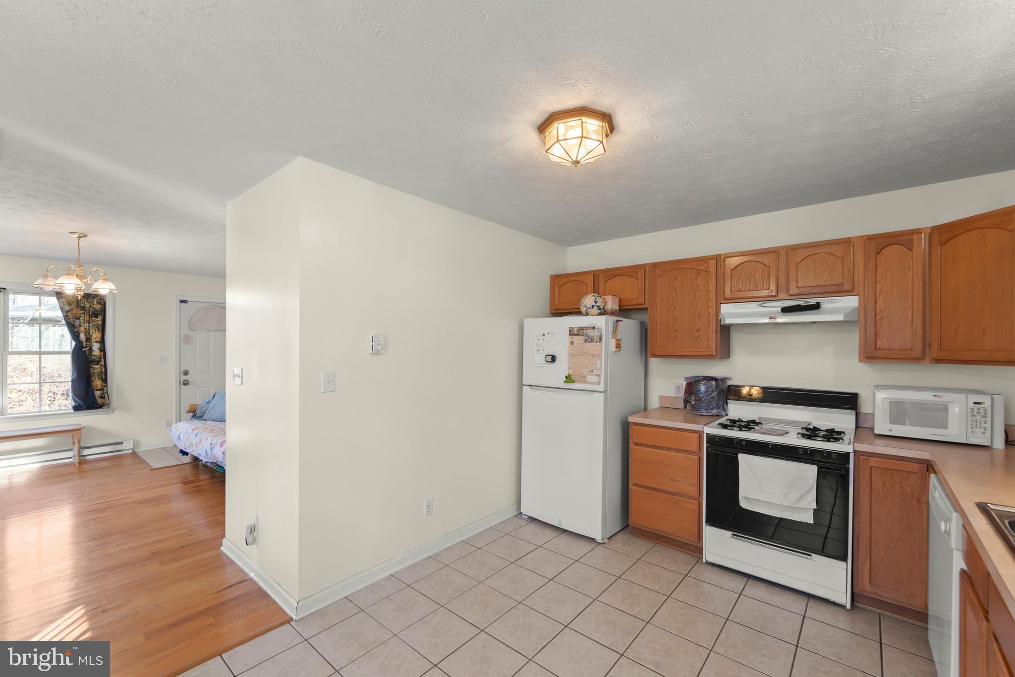 1060 Buffalo Rdg Road Augusta, WV 26704 - Photo 9 of 67 a kitchen with a stove a refrigerator and a sink