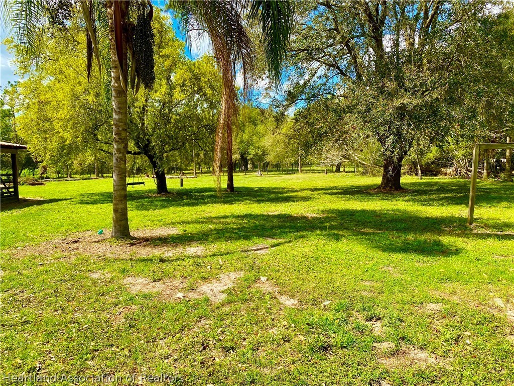538 Hayman Road Wauchula, FL 33873 - Photo 8 of 21 a big yard with swimming pool in front of it