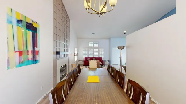 a living room with furniture a dining table and a stove top oven