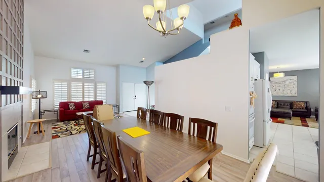 a living room with furniture a dining table and a stove top oven