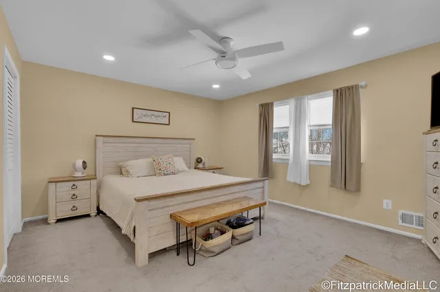 a bedroom with a bed and a night stand