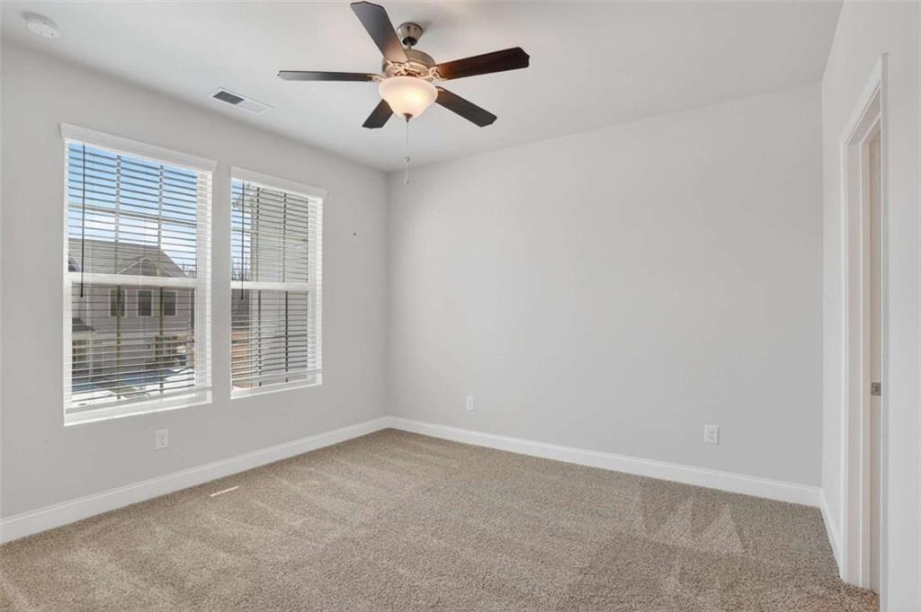 3405 Ripple Loop, Unit 127 South Fulton, GA 30349 - Photo 11 of 26 an empty room with a window and a ceiling fan