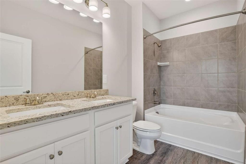 3405 Ripple Loop, Unit 127 South Fulton, GA 30349 - Photo 14 of 26 a bathroom with a granite countertop sink a toilet and bathtub