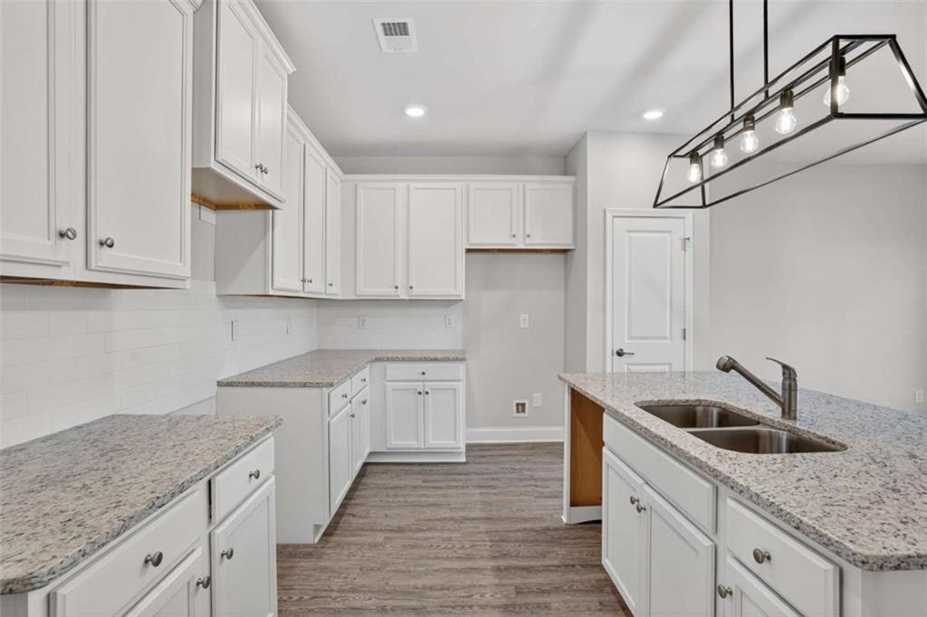 3405 Ripple Loop, Unit 127 South Fulton, GA 30349 - Photo 4 of 26 a kitchen with granite countertop a sink and cabinets