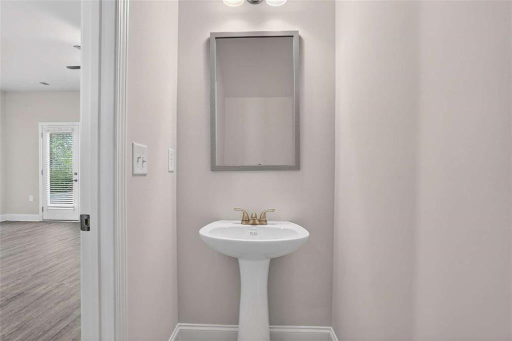 3405 Ripple Loop, Unit 127 South Fulton, GA 30349 - Photo 9 of 26 a bathroom with a sink and a mirror