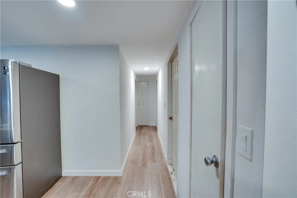 3700 Buchanan Street, Unit 189 Riverside, CA 92501 - Photo 12 of 44 a view of a hallway with wooden floor