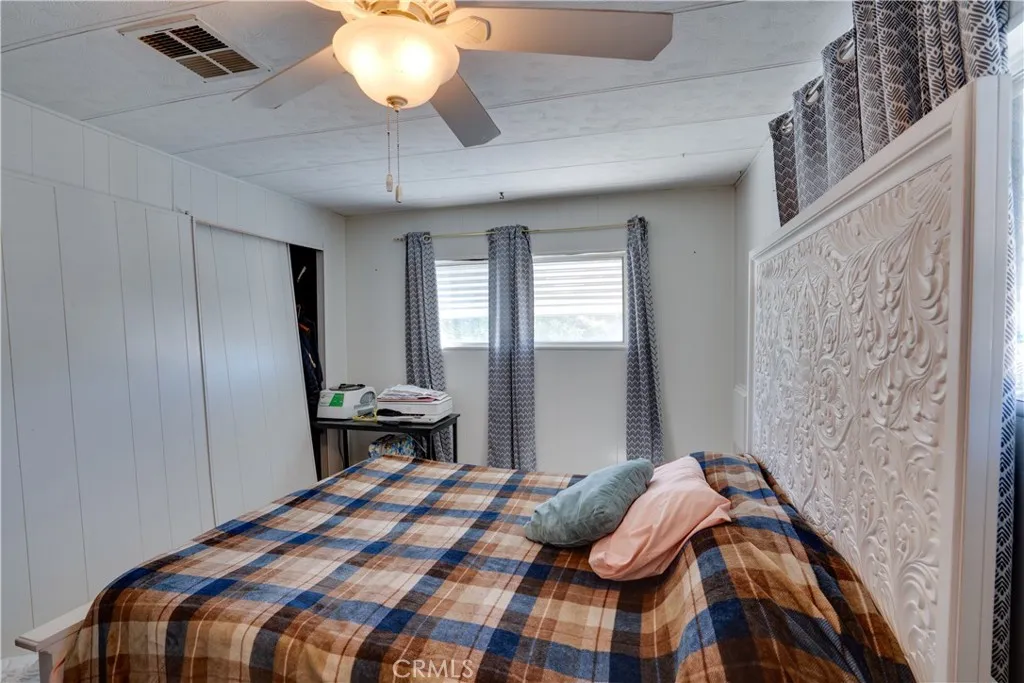 3700 Buchanan Street, Unit 189 Riverside, CA 92501 - Photo 8 of 44 a bedroom with a bed and a chandelier