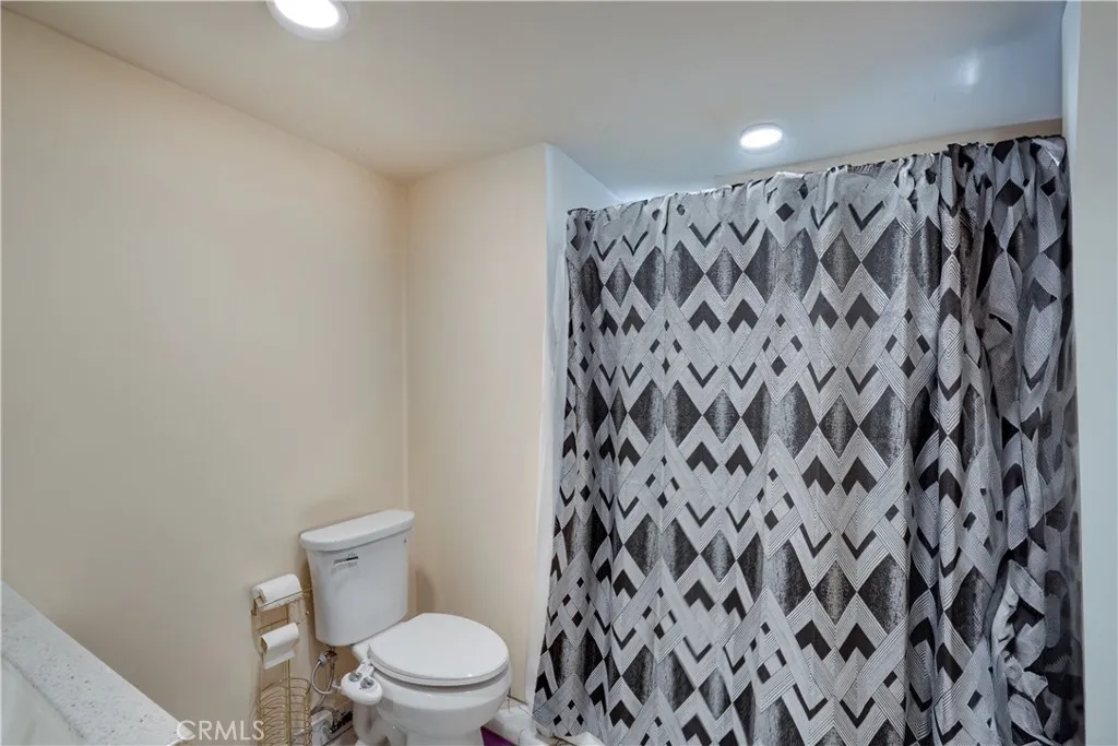 3700 Buchanan Street, Unit 189 Riverside, CA 92501 - Photo 10 of 44 a white toilet sitting next to a shower curtain