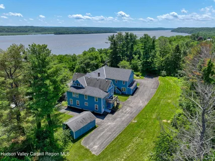 an aerial view of a house with swimming pool and garden