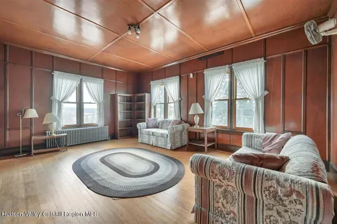 a spacious bedroom with a bed and a chandelier