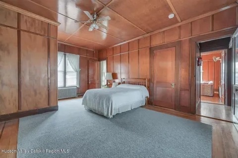 a bed room with a bed and a chair