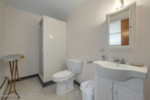 a front view of a house with yard and large tree