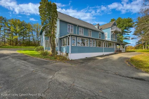 a view of a backyard with large trees
