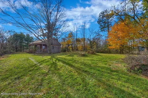a front view of a house with a garden and plants