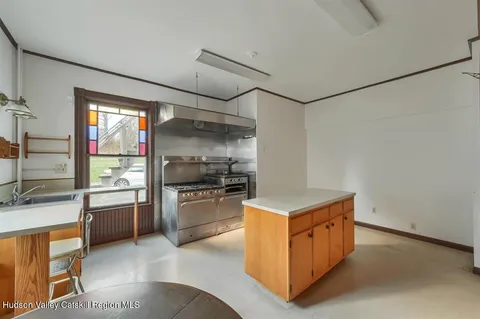 a view of a kitchen with a sink and cabinets