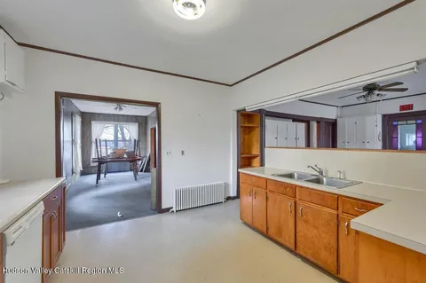 a large kitchen with stainless steel appliances granite countertop a lot of counter space and wooden floors