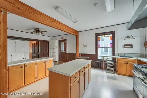 a view of a kitchen with sink and a refrigerator