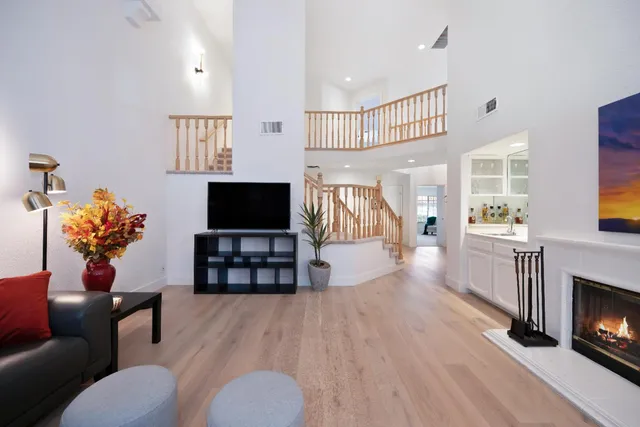 a living room with furniture a flat screen tv and a fireplace