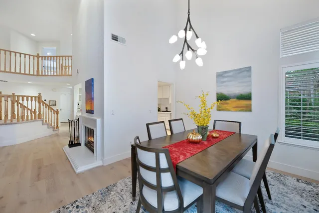 a view of a dining room with furniture and a chandelier