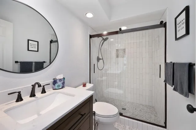 a bathroom with a sink toilet and shower