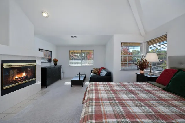 a bedroom with a bed and a fireplace