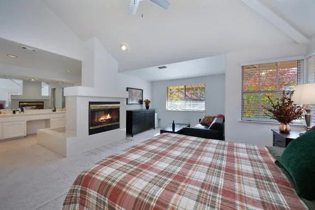 a large bedroom with a bed and a fireplace