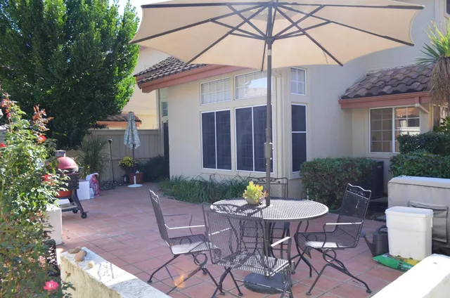 a view of a chair and table in backyard