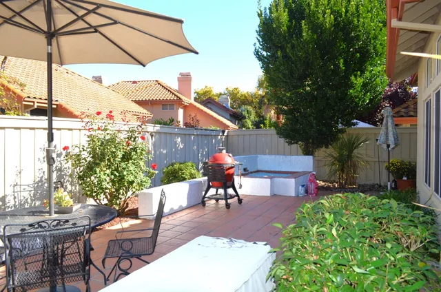 a view of a chairs and table in the patio