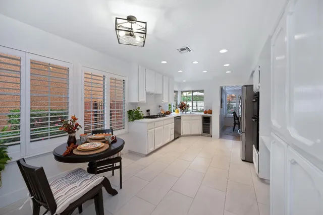 a kitchen with a refrigerator and a sink