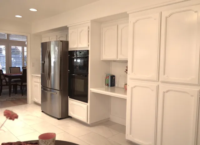 a kitchen with stainless steel appliances a refrigerator and cabinets