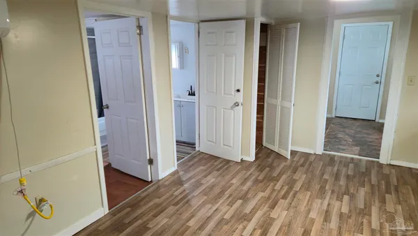 a view of a room with furniture and wooden floor