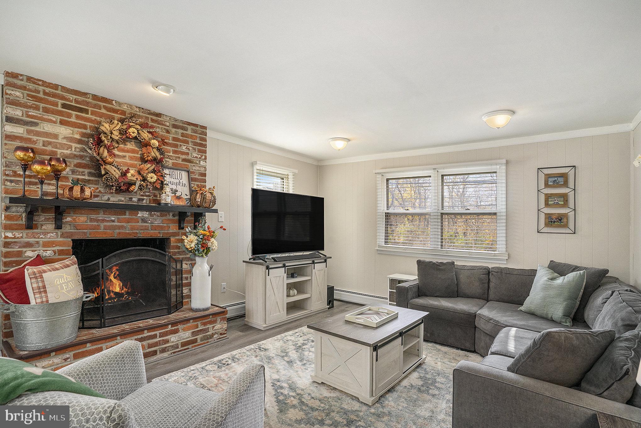 1271 Phoenixville Pike West Chester, PA 19380 - Photo 11 of 33 a living room with furniture a fireplace and a flat screen tv