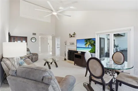 a living room with furniture a rug and white walls